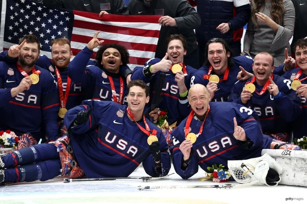 Team USA team celebrating their gold medal victory at the Paralympic games.